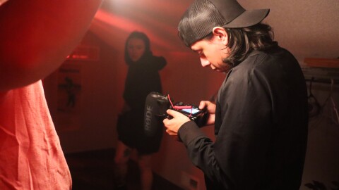 Members of team BOY BRAINS examine footage while on set for their short film, My Friend's Mom's Necronomicon, for the 48 Hour Horror Film Project.
