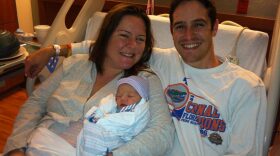 Samantha Evans (left) and Jonathan Evans (right) hold their newborn, Allison Elizabeth, who was born on February 29, 2012. They say they will call her their little "Leapling." (photo by Lauren Rautenkranz)