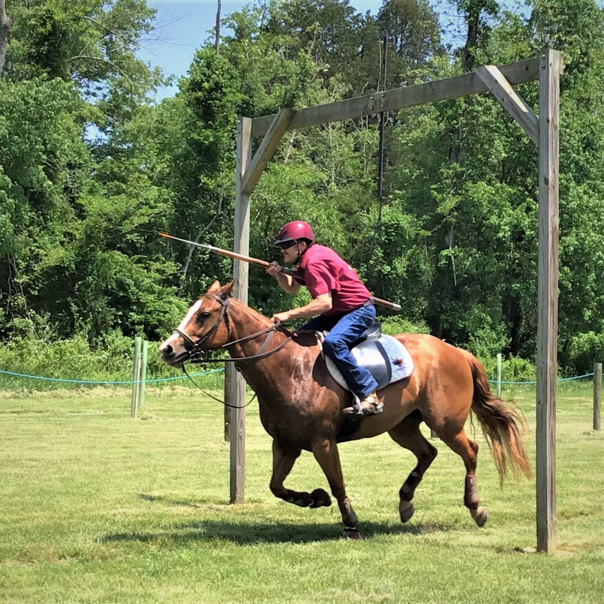 Jouster Bob Enfield lances a ring at a tournament in Kingsville, Maryland (Photo credit: Aaron Henkin / WYPR)