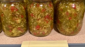 Jars of chow-chow sit on a shelf with a label that reads "2025" 