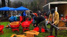 Relief volunteers ready wheelbarrows to gather and take away debris from Blue River, which was severely hit by 2020's Holiday Farm Fire.