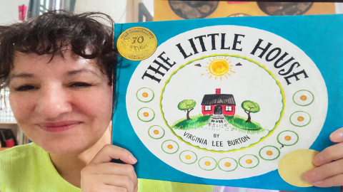 Sandra Cisneros holds up a copy of The Little House by Virginia Lee Burton.