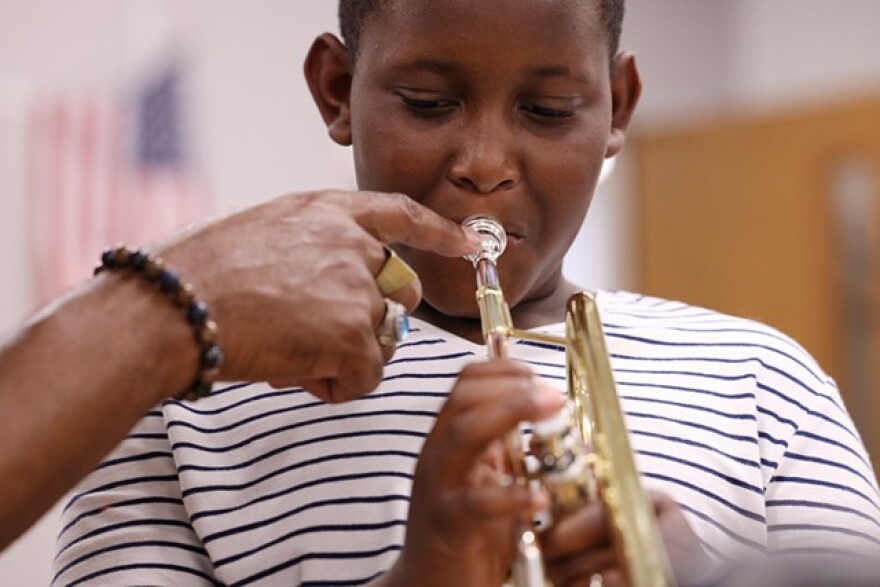 Cameron Terry takes direction from Herb Smith during a lesson.