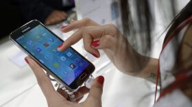 A Samsung Galaxy S5 is demonstrated at the Mobile World Congress, the world's largest mobile phone trade show in Barcelona, Spain. CREDIT: FERNANDEZ/AP