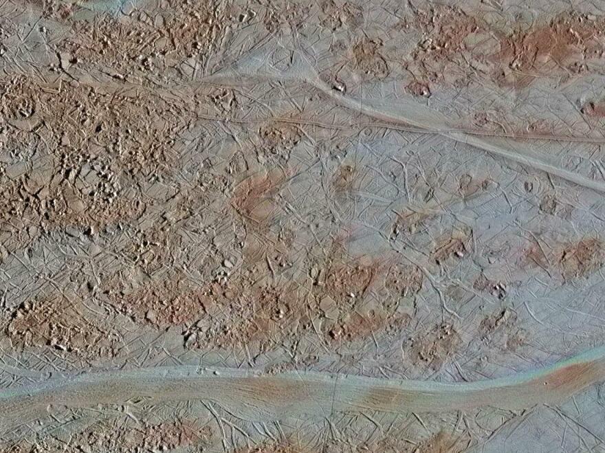 An image of Europa's surface shows a region of "chaos terrain," where the surface has broken apart into many smaller chaos blocks that are surrounded by a featureless matrix material.