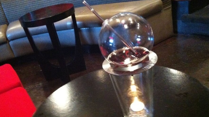To mix up a Vaportini, add your favorite spirit to the glass globe and light the candle below. A few minutes later, vapors fill the glass with flavors and alcohol.