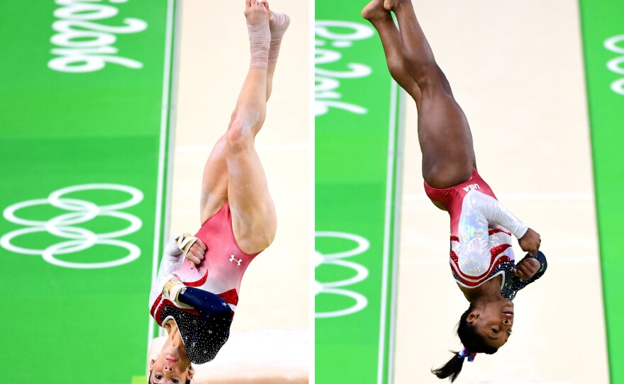 Aly Raisman (left) and Simone Biles (right) of the United States compete on the vault during the women's team final.
