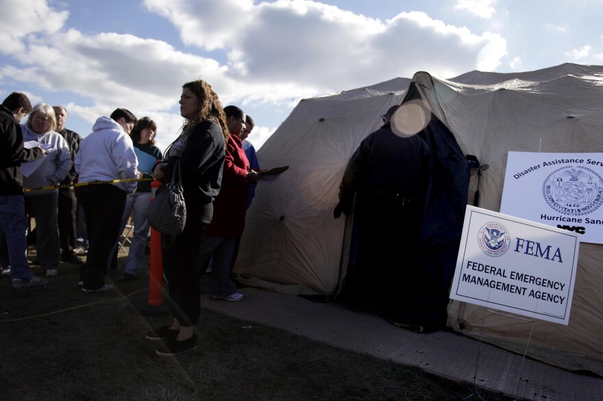 Residents affected by Superstorm Sandy wait outside a FEMA tent in 2012. FEMA has made disaster legal services available after past disasters, including Sandy and hurricanes Harvey, Irma and Maria.