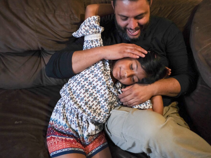 Jose Grajeda and his daughter, Victoria, cuddle before bedtime in Alpine, Tex. When Grajeda was a kid, he remembers how his parents employed a soothing caress to send him to sleep. Now he uses it with his kids. "You scratch someone's back, or their head, with the tip of your fingers. And you do it very lightly and softly," Grajeda explains.