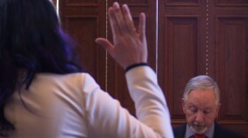 a person's hand up, an individual looking down