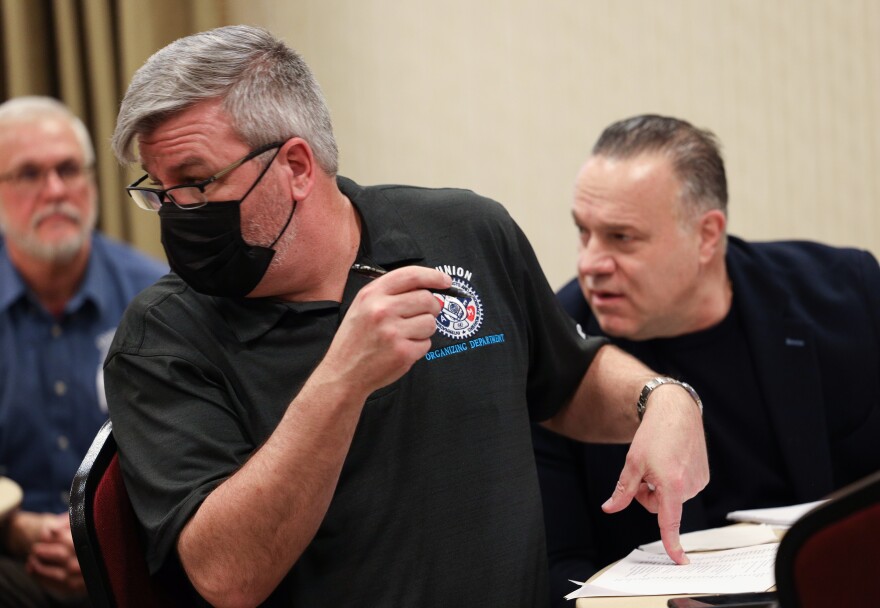 Mike Evans with the International Association of Machinists and Aerospace Workers, keeps a running tally of votes counted as employees from the Veterinary Specialists and Emergency Service gathered to hear the counting of votes by the National Labor Relations Board after they cast ballots to organize and form a union.