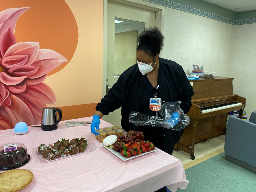 Hopkins prepares the table moments before the patients arrive for a tea party.