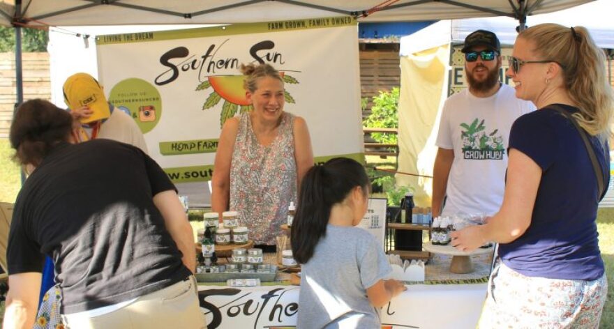 Barbara Stalbaum and Tyler Griffin, helping customers at Gainesville Grove Street Farmers Market