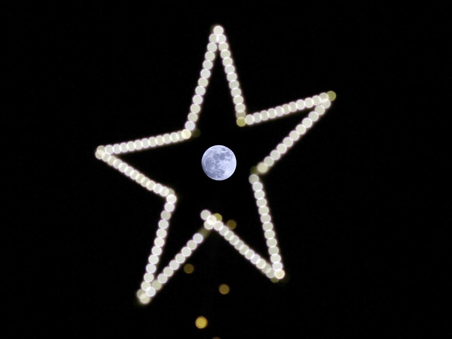 The full cold moon seen through the star of a Christmas tree in Beirut, on Dec. 24.