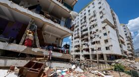 A damaged building with debris scattered in the foreground in the Playa Grande neighborhood of Catia la Mar, La Guaira state, Venezuela, on Wednesday, July 1, 2026, after earthquakes the previous week. (Miguel Medina/AP)