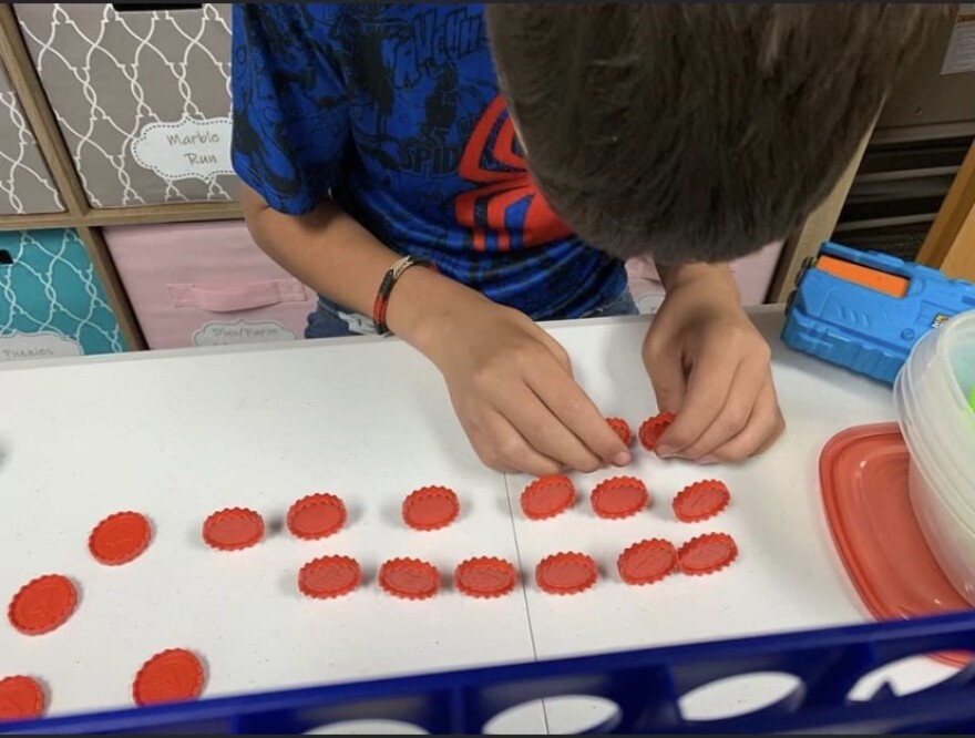 A boy in foster care plays a game while waiting for placement with a foster family (Courtesy of Cindy Floyd).