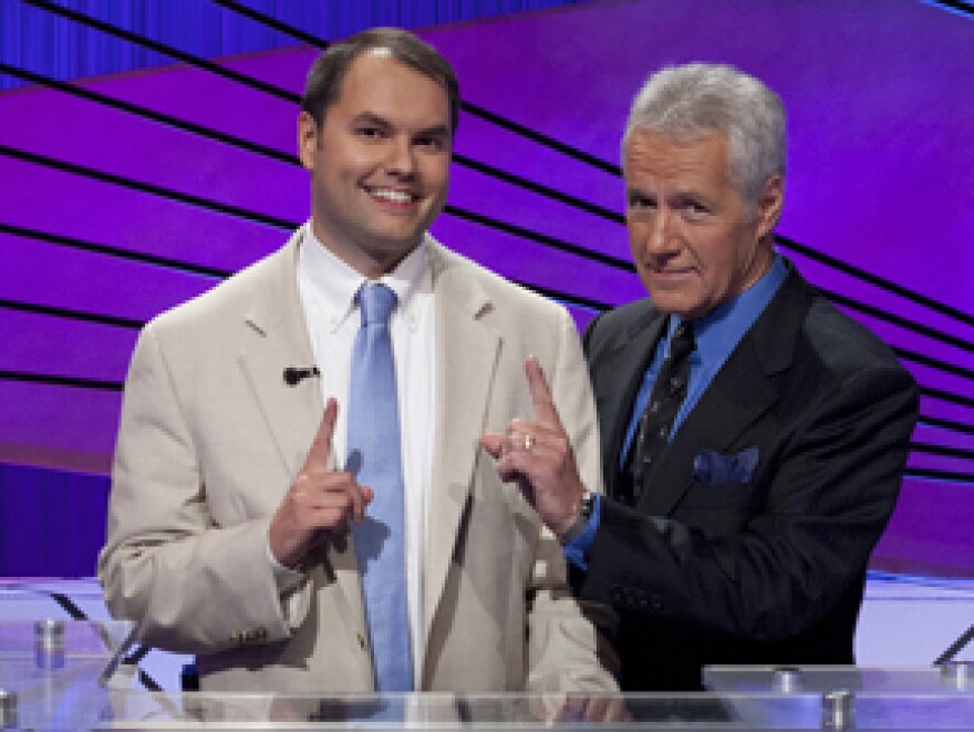 Roger Craig poses with <em>Jeopardy!</em> host Alex Trebek after winning $250,000 in last week's Tournament of Champions.