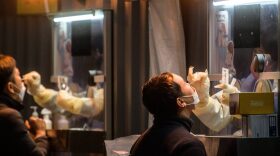 Health workers carry out PCR (polymerase chain reaction) tests at a Covid-19 coronavirus testing centre in Seoul.