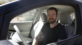 Edmond resident Jonathon Stranger in his 2013 Nissan Leaf, an all-electric car.