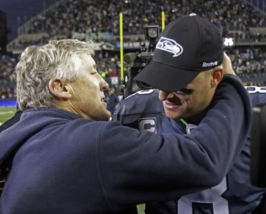 Love 'em or leave 'em: Matt Hasselbeck hugs coach Pete Carroll after the Seahawks beat the Saints in the NFC Wildcard playoff game Jan. 8, 2011. Art Thiel says Hasselbeck will be a free agent whenever NFL players get a new contract.