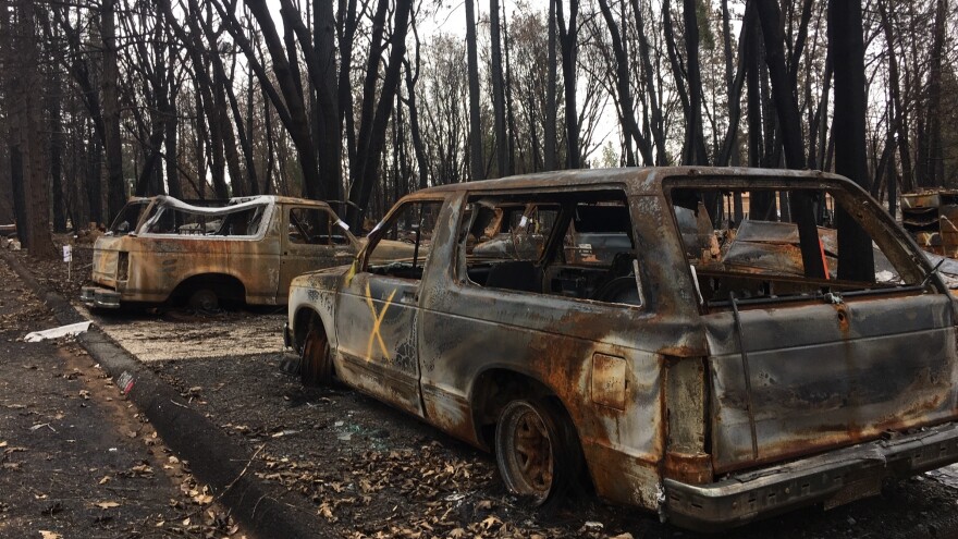 Burned out cars remain stranded in the driveway of a home destroyed by November's Camp Fire. Clean up is just beginning in the town where over 14,000 homes were incinerated. PG&E is under investigation for possibly starting the blaze.
