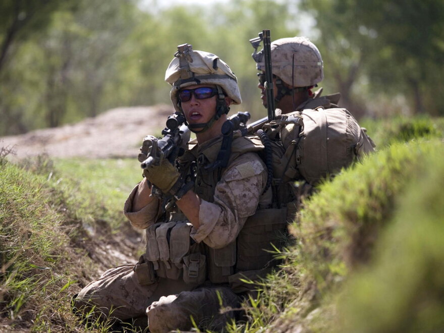 U.S. Marines take cover as they are involved in a gun battle in March during a patrol in Marjah, Afghanistan.  In February, U.S.-led troops set out to rid the area of insurgents and set up a viable local government. But Taliban militants have returned to the area.