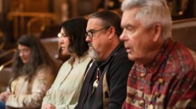 Four people sitting in a row.