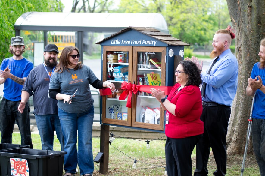 Chaz and Tricia Fillion, in gray, were joined by Library Director Jennifer Brown, Branch Manager Douglas Keith, and representatives from Bear Creek Outdoor Living.