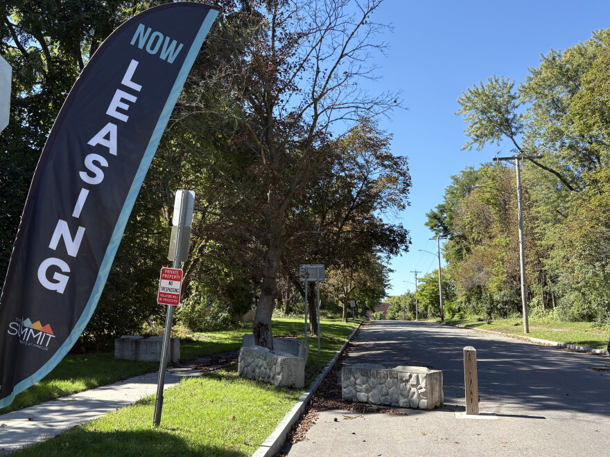 Signs advertise apartments for lease at the Smith St. entrance to Summit.