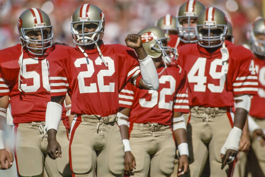 Dwight Hicks (#22) psychs up before a 1985 game, flanked by San Francisco 49er teammates. Now a lead actor in <em>X's and O's (A Football Love Story)</em>, Hicks played nine seasons in the NFL.