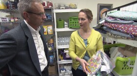 Advocate Jamie Manzer, right, shows reporter Mike Tobias a bag of essential items that a nonprofit gives trafficking victims.