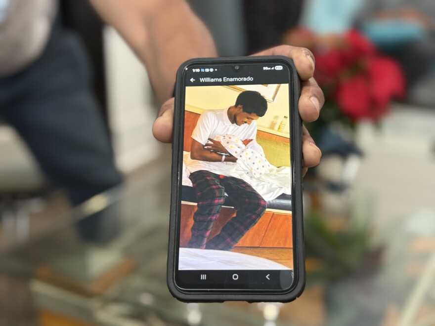 A relative shows a photograph of Williams Javier Toro Enamorado with his newborn son. Enamorado was one of hundreds of people detained by federal immigration officers during "Operation Charlotte's Web,"