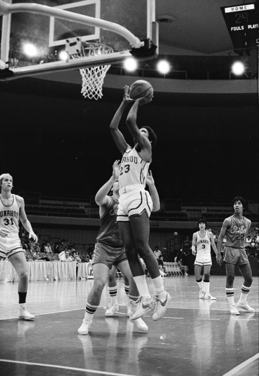 Obama shoots the ball while playing for the Punahou School basketball team in 1979.