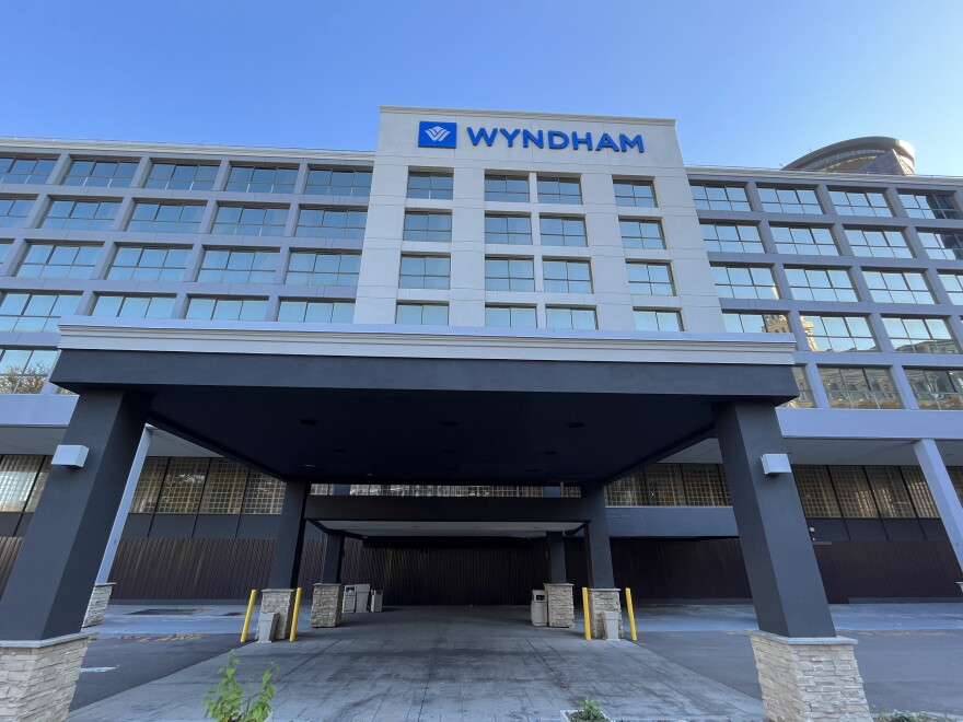 The former Wyndham hotel on State Street in downtown Rochester is closed and wrapped in corrugated steel.