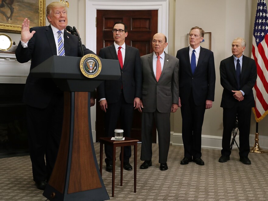 President Trump delivers remarks before signing tariff proclamations on steel and aluminum imports at the White House on March 8. Treasury Secretary Steven Mnuchin (second from left), Commerce Secretary Wilbur Ross, U.S. Trade Representative Robert Lighthizer and White House National Trade Council Director Peter Navarro look on.