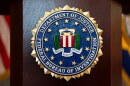 FILE - An FBI seal is displayed on a podium before a news conference at the field office in Portland, Ore., Jan. 16, 2025. (AP Photo/Jenny Kane, File)