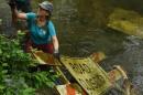 Laura Semken works to lift a large sign out of Flat Branch Creek on Wednesday at the MKT Nature and Fitness Trail in Columbia. Semken, a member of the Missouri River Relief crew, said the creek is "near and dear to my heart." She has been helping maintain the area since moving to Columbia in 2019.
