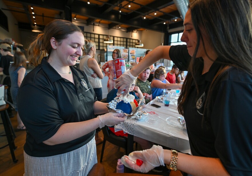 Abby Walsh and Julia Gallo of the University of Scranton prepare pancakes with a red, white and blue theme.