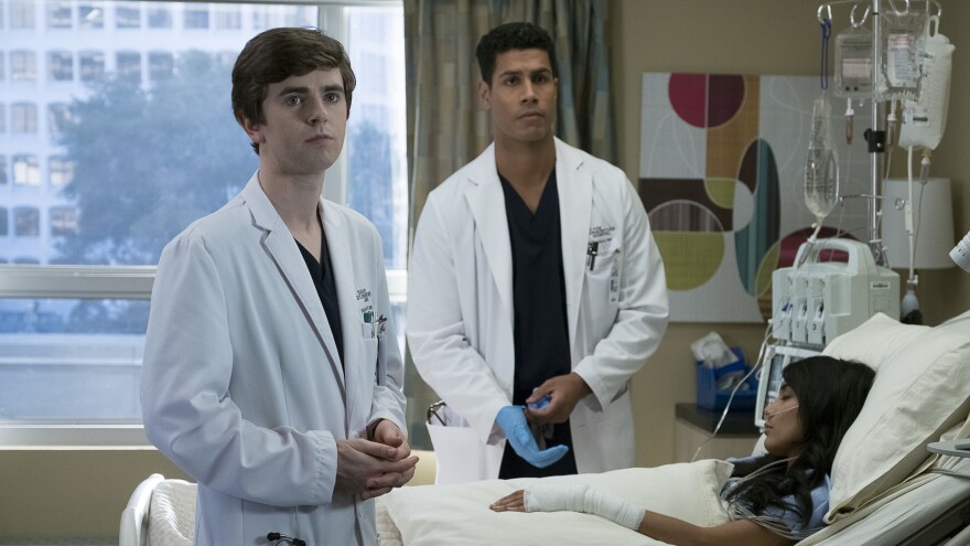 Dr. Shaun Murphy (Freddie Highmore) and Dr. Jared Kalu (Chuku Modu) treat a patient on <em>The Good Doctor</em>.