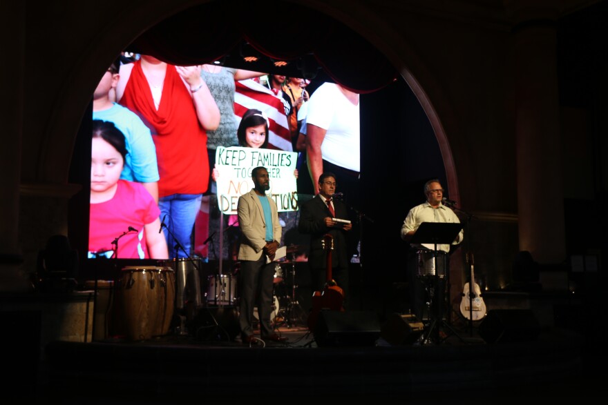 Abey Lissane, left, prepares to speak to the crowd at a kickoff event for TIRRC Votes, an advocacy program aimed building political support for immigrants.
