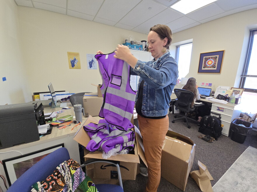 Reverend Breanna Illéné is unpacking supplies to distribute to poll chaplains around the state of Wisconsin.