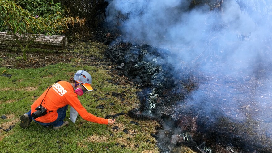 A Hawaiian Volcano Observatory geologist collects samples of spatter for laboratory analysis on Sunday in the Leilani Estates subdivision near Pahoa.