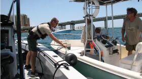 Two boater pull alongside a Florida Fish and Wildlife boat for a check of their safety preparations