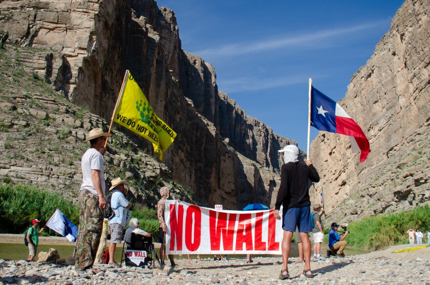 Terlingua resident John Rakowitz waves an anti-border wall version of the Gadsden flag that reads “Don’t tread on Big Bend. We do not need the wall.”