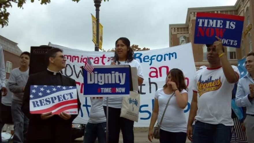 woman speaks in front of crowd