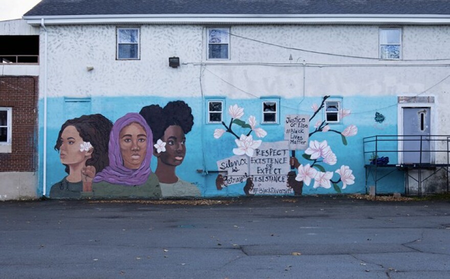 The “Black Lives Matter” mural was painted on the side of The Flying Squirrel Community Space on Clarissa Street by youth artists Nzinga Muhammad, Kaori-Mei Stephens, and Etana Browne in 2017 in collaboration with ROC Paint Division and Wall\Threrapy.