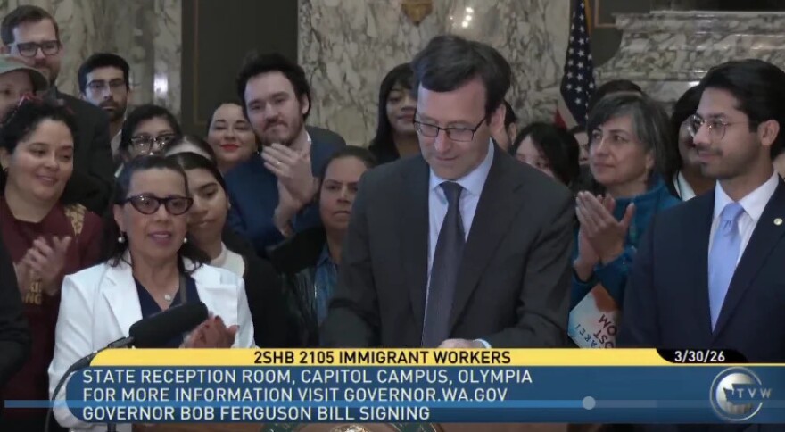 Gov. Bob Ferguson signs a bill on March 30, 2026, that will notify immigrant workers when a federal agency announces an upcoming inspection of the business’ I-9 forms on file. Employers use the I-9 and related documents to verify employees’ identity and work authorization.