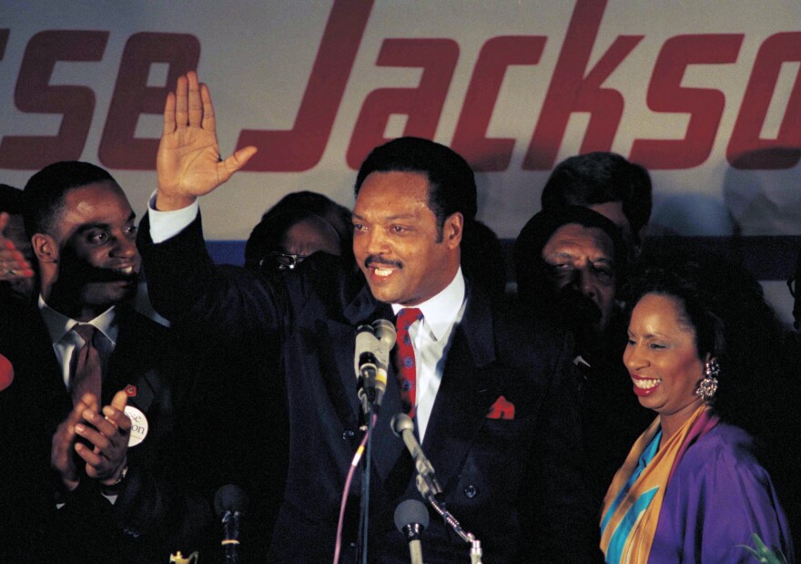FILE - Jesse Jackson, with his wife Jacqueline, concedes defeat in the Illinois Democratic primary on March 16, 1988, in Chicago. (AP Photo/Lisa Genesen, File)