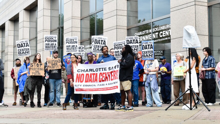 Robert Dawkins, political director for Action NC, addresses a crowd gathered in front of the Charlotte-Mecklenburg Government Center.