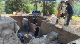 Members of a University of Alaska crew carefully excavate soil from the site of an ancient dwelling on Hollembaek Hill in the agricultural area south of Delta Junction.